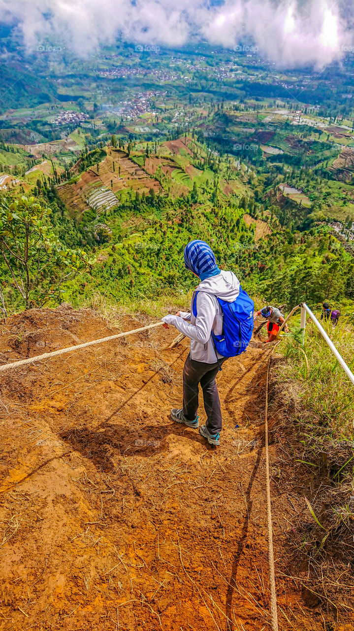 Descending down a mountain in Central Java. The trail equipped with rope to ease the journey up and down.