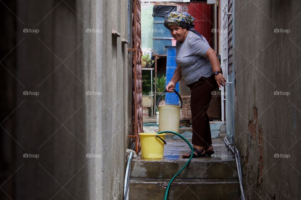 Woman Carrying Bucket With Water In Cuba