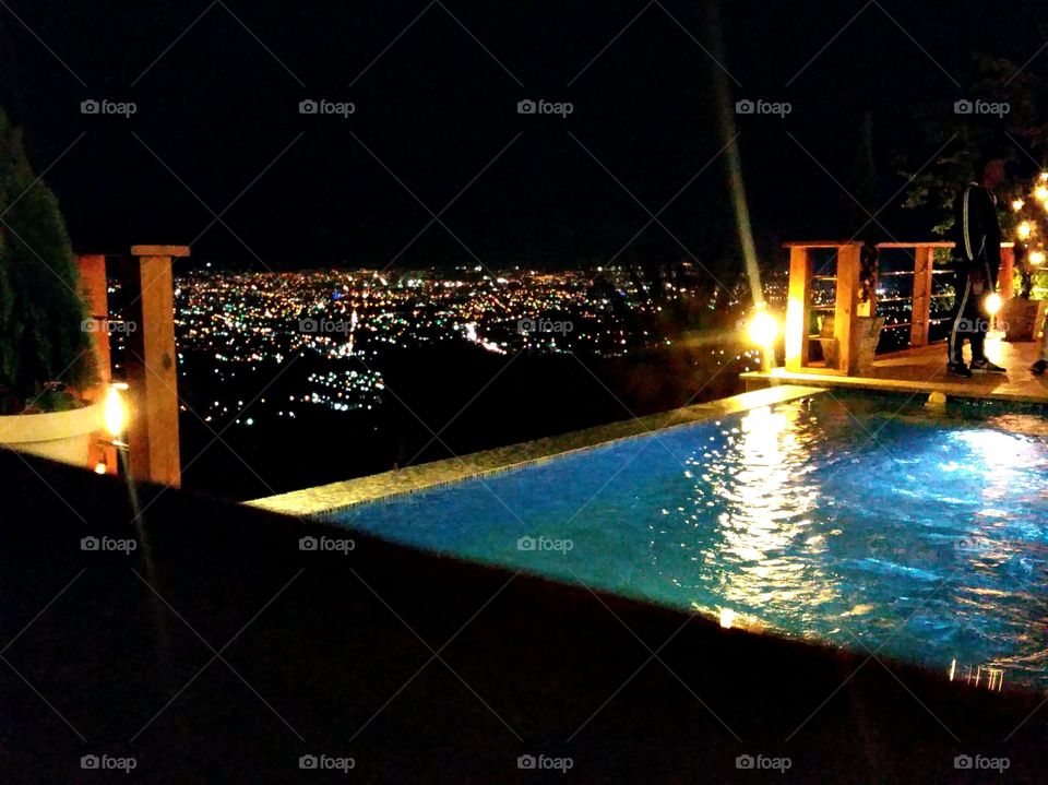 infinity pool jacuzzi overlooking the city lights