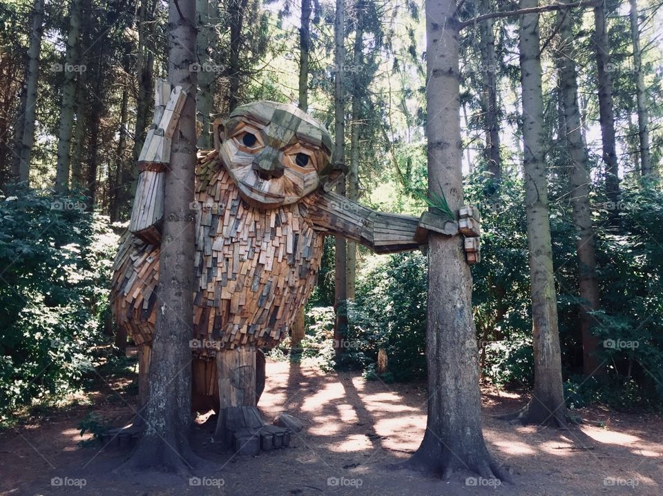 Hidden giant in the forest of Denmark, large wooden structure with a friendly face.
