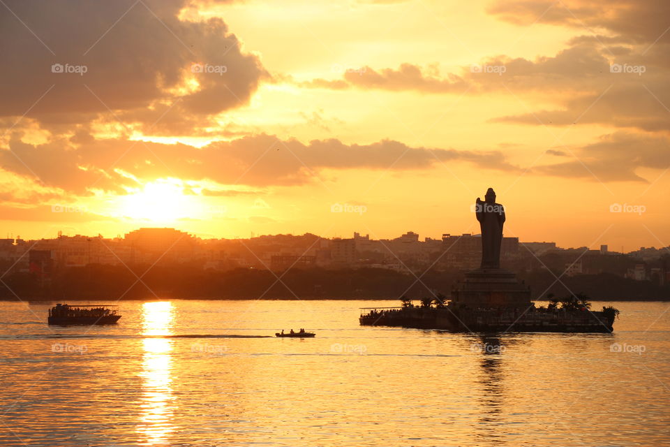 Beautiful sunset At lake view, Budha statue