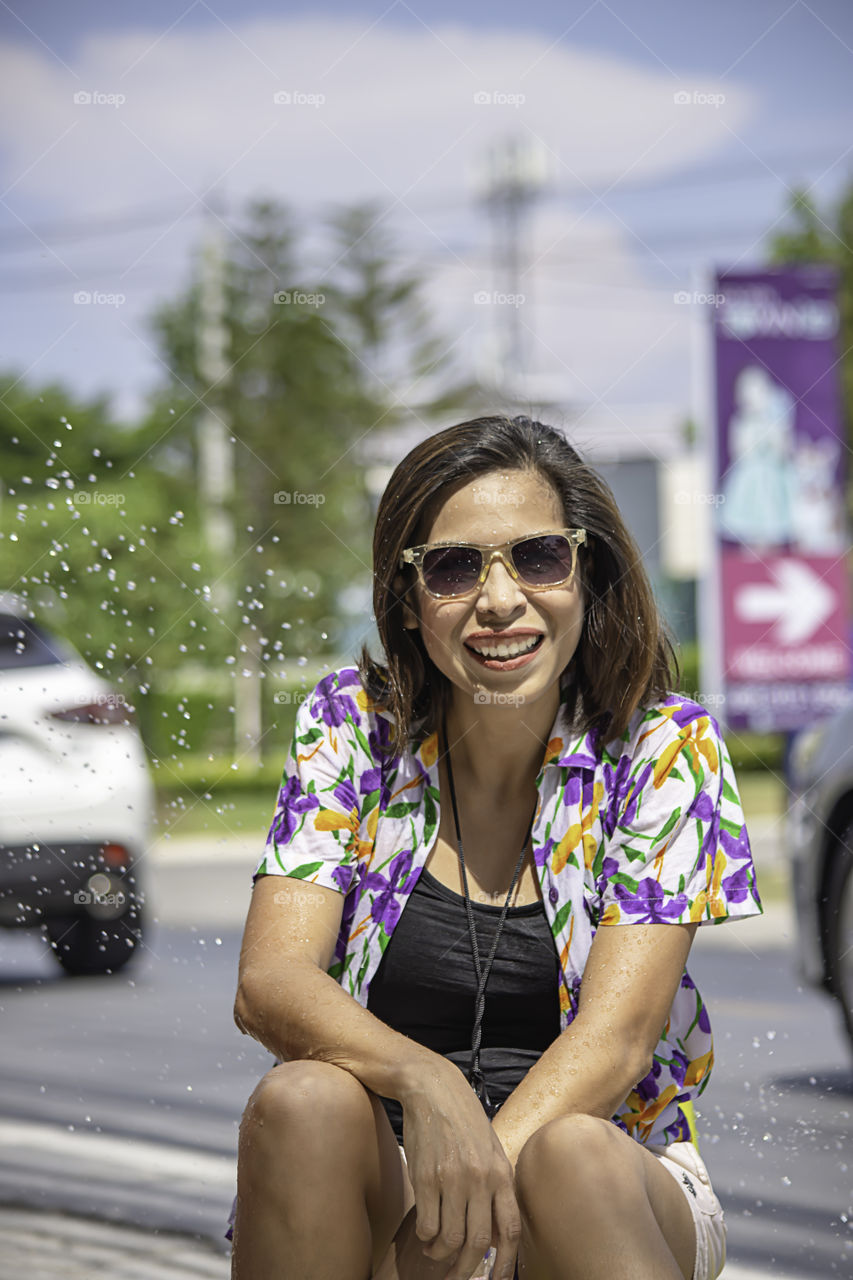 Asian woman play water in Songkran festival or Thai new year in Thailand.