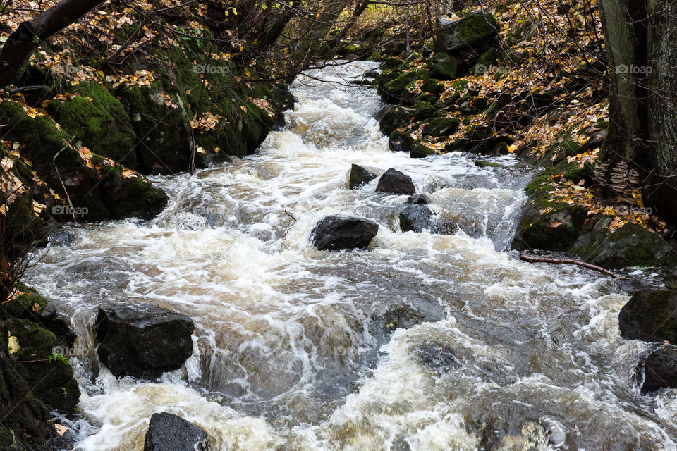 Creek with waterfall in autumn 