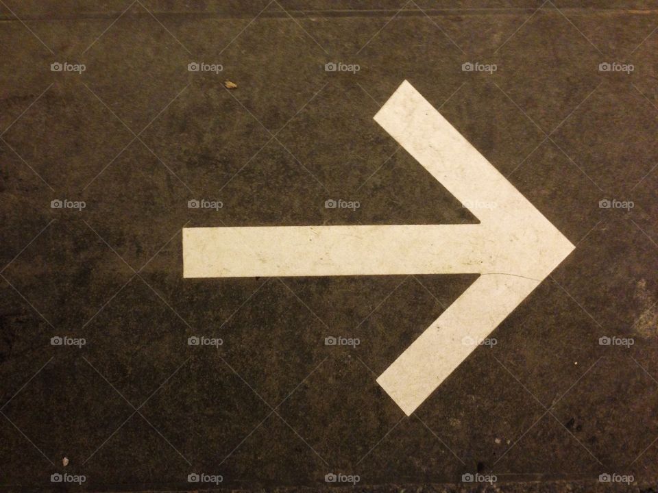 White arrow sign pointing to the right