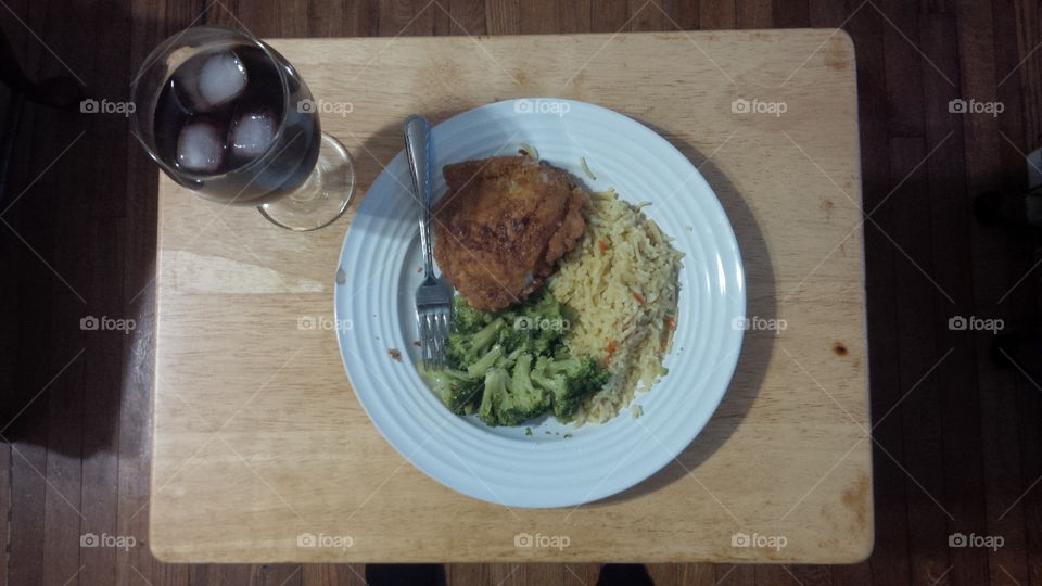 Fried Chicken Dinner With Rice and Buttered Broccoli With A Glass Of Soda