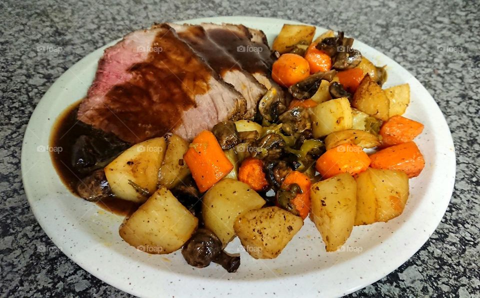 Delicious plate of beef roast with gravy and roasted vegetables, South Africa