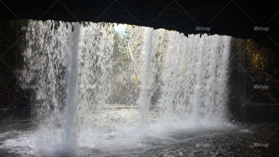 under waterfall