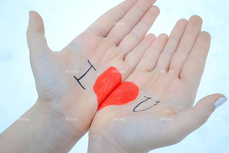 Text and heart shape on person's hand