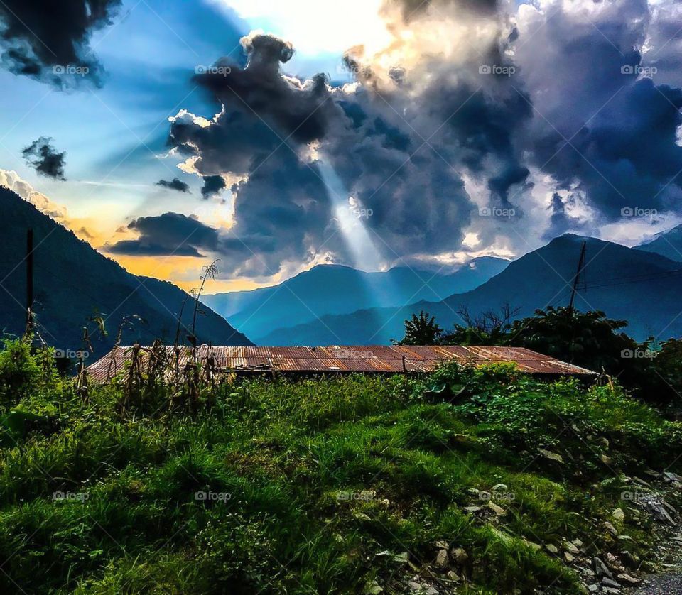 A sunburst shoots down from the clouds on our bus journey to Beni from Kathmandu. Photo taken just before starting the Dhaulagiri Circuit Trek in Nepal.