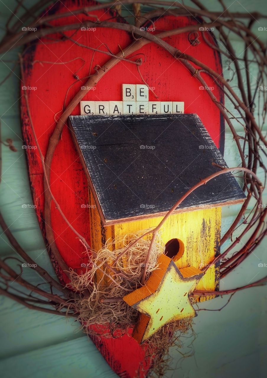 Be Grateful written on a bird house with star and a big red heart full of love and gratitude for life and living