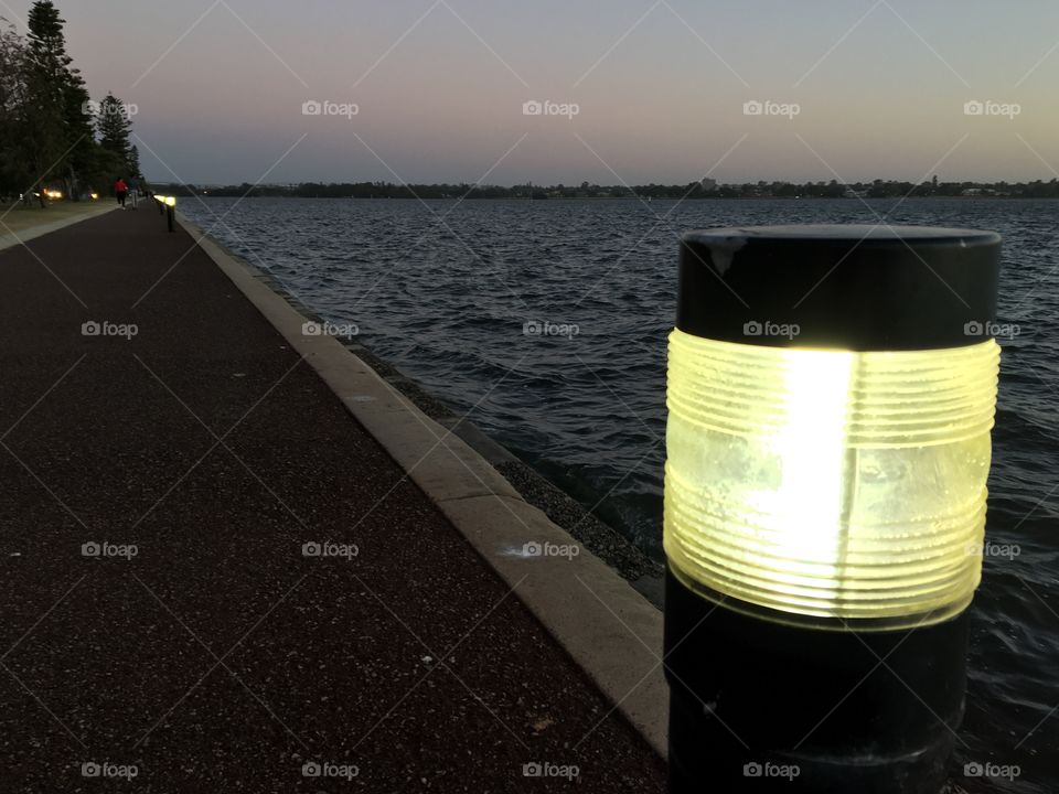 The light from sunset and technology at the riverside.