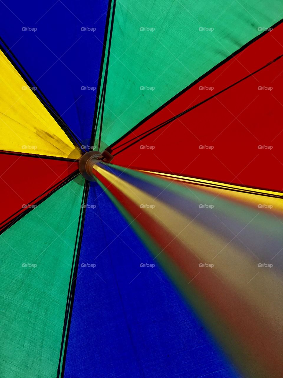 Colourful summer umbrella: red, blue, green, yellow, stripes. 