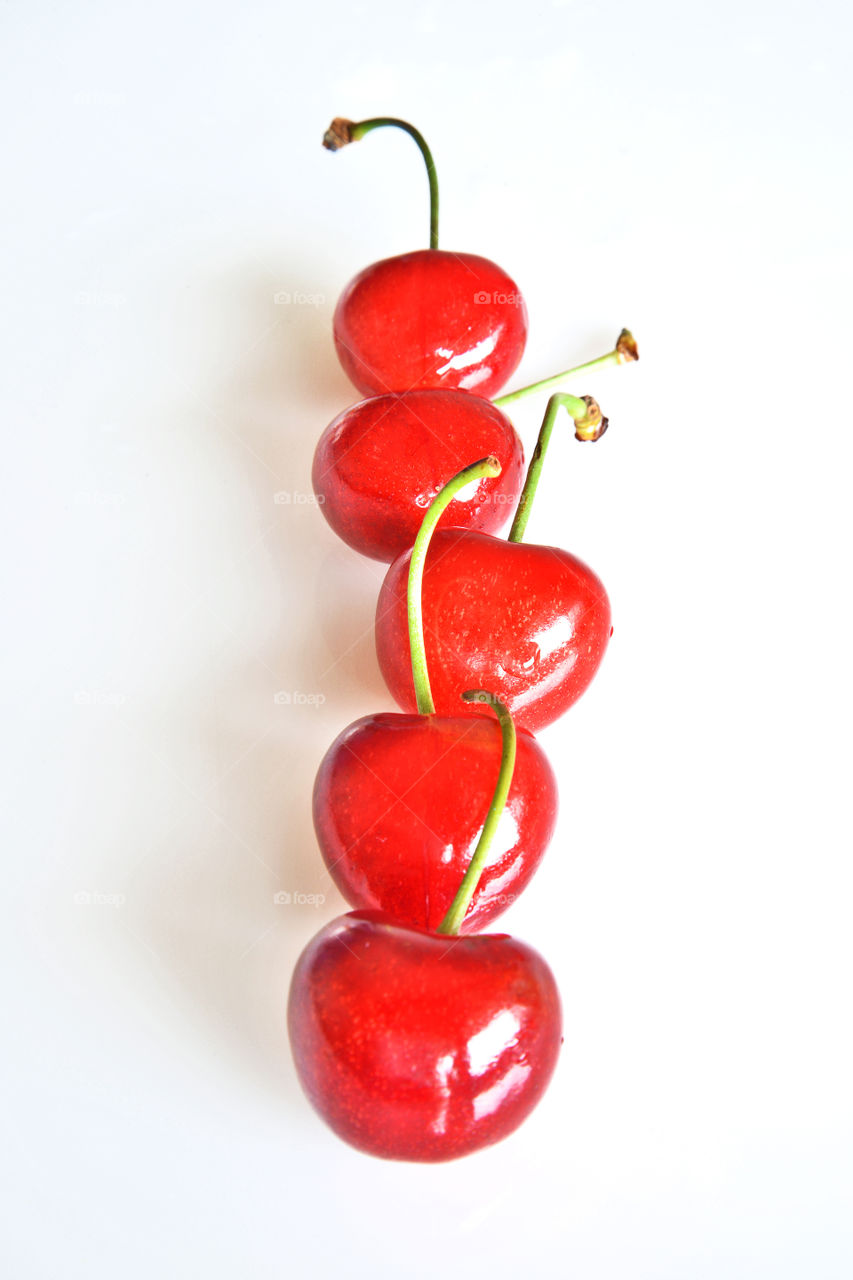 Fresh cherries against white background