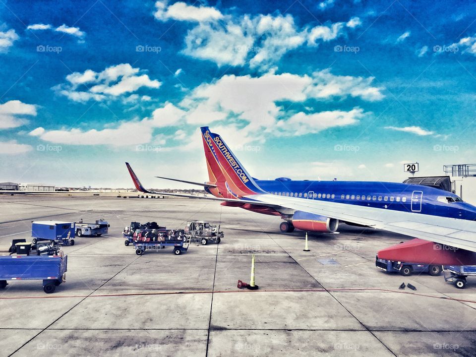 Southwest planes on tarmac with luggage carts 