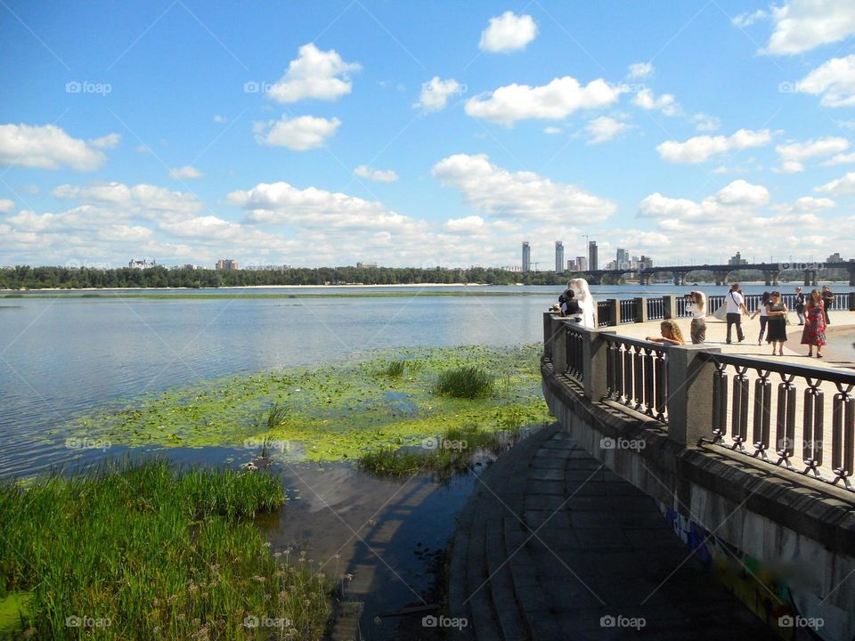 A couple taking wedding photos in Kiev outlook, with panoramic views of the city. Before the war. 