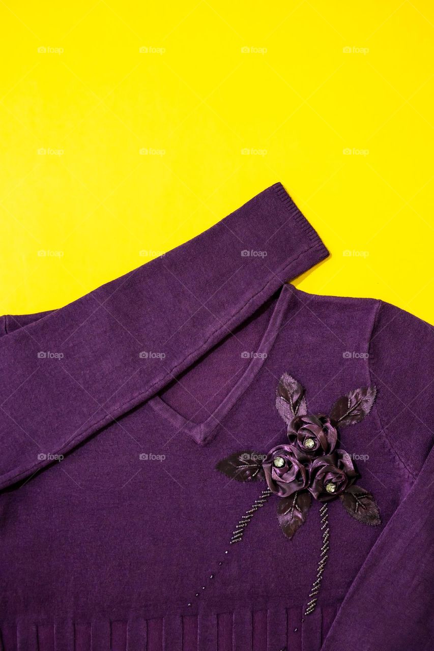 A purple top on a yellow background