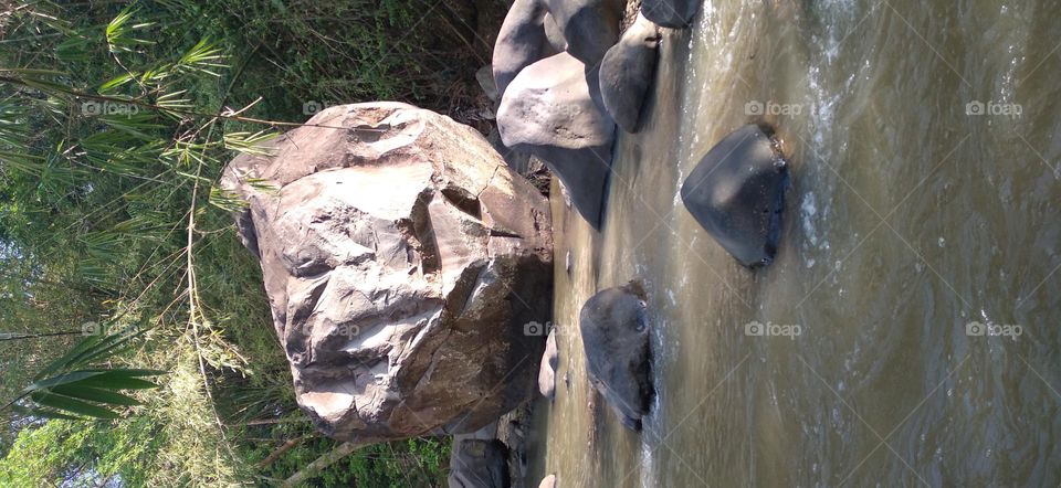 This big rock is in the middle of the river