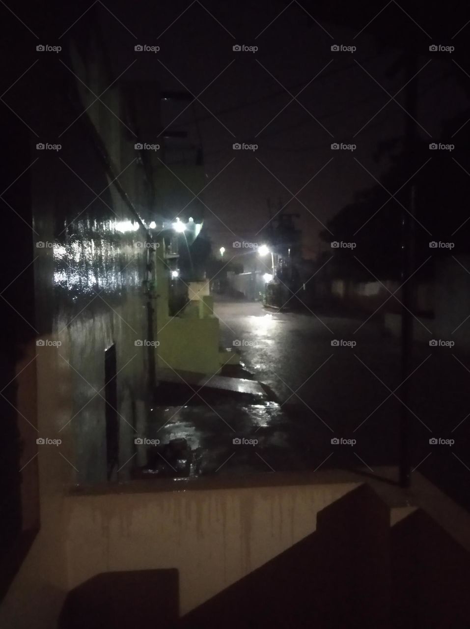 submitted this photo for mission rainy citie, a rainy night scene, it's raining here, water is on the road, lighting also