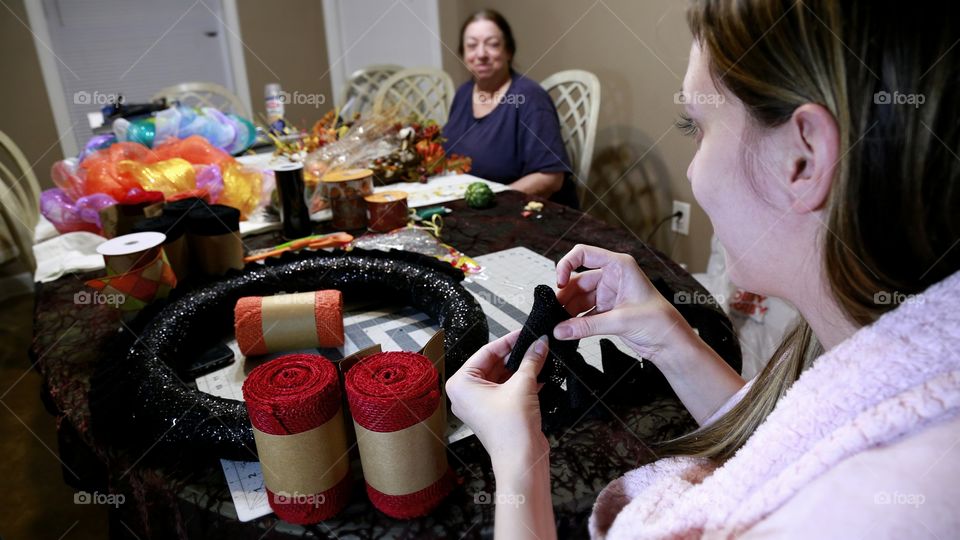 Mom and Daughter Share a Laugh While Making Crafts