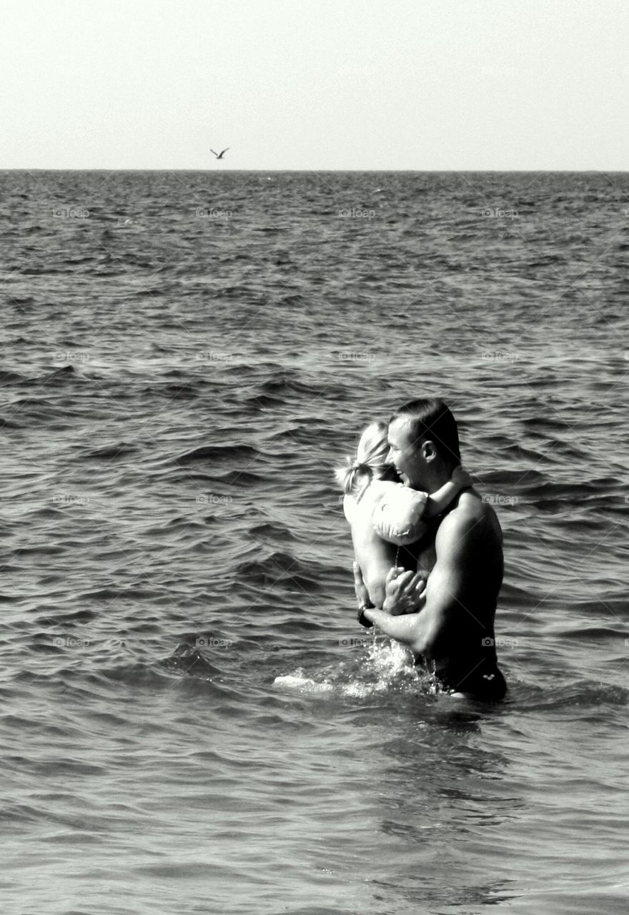 Father swimming with his daughter