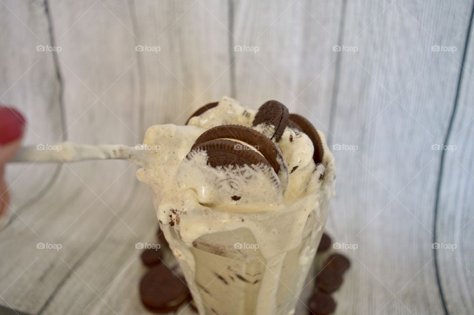 Oreo cookie milkshake with a wooden rustic white background