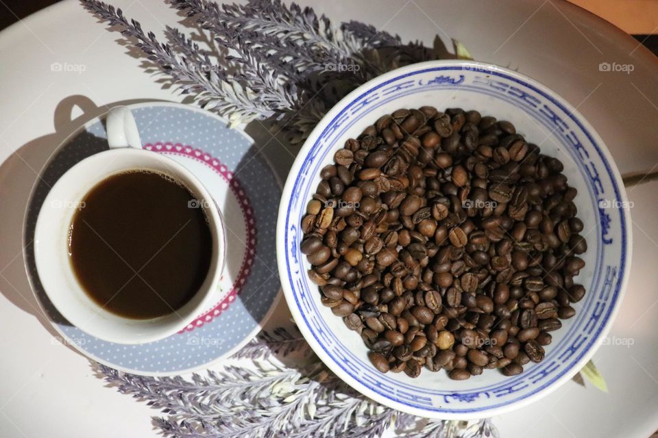 A cup of coffee and coffee beans