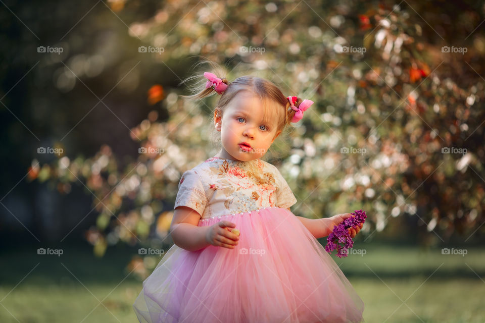 Cute little girl in a blossom park 