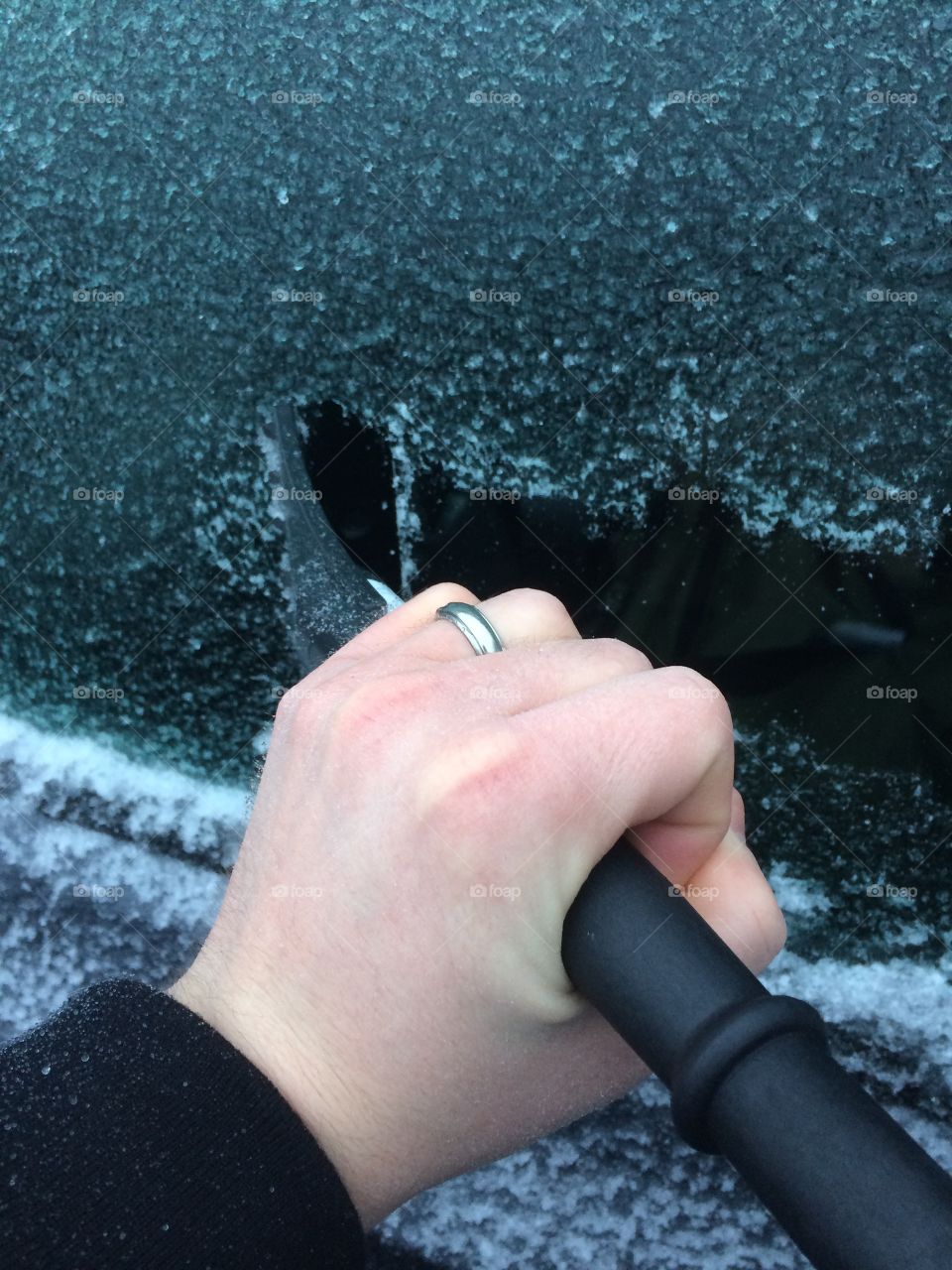 Scrapping ice from the car windows. 