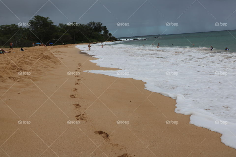 Footsteps on a sandy beach 