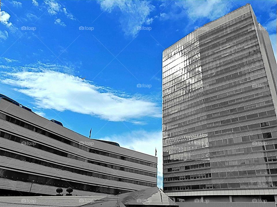 How does it look like a colorless building in relation to the blue sky?