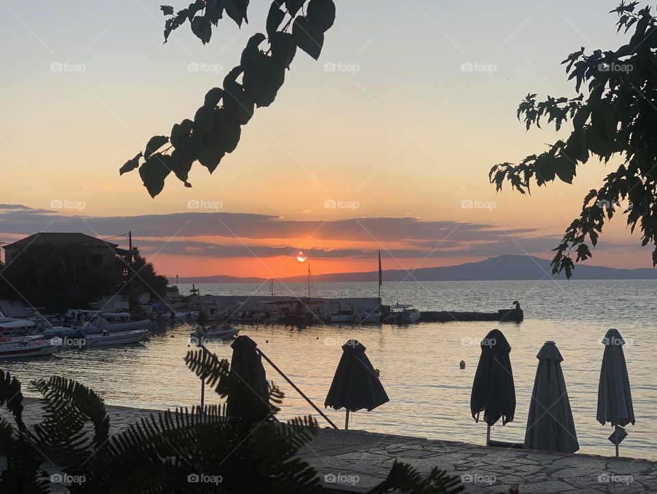 Sunset over the Mediterranean Sea from a small Greek town harbour