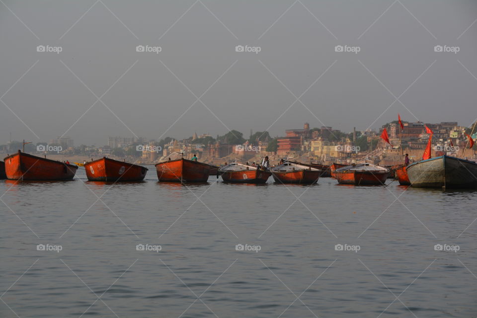 Red boats floating on the Ganges river, India