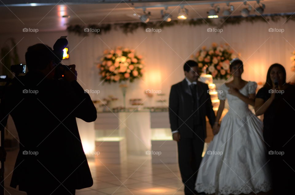 Photographer taking a picture of the bride and the groom 