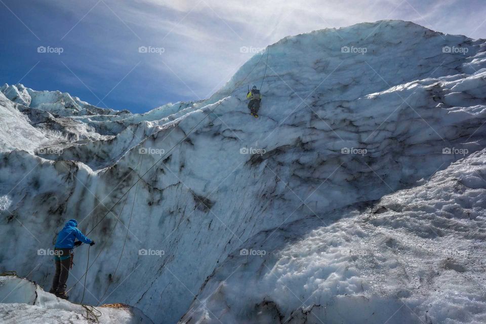People climbing on snowy mountain