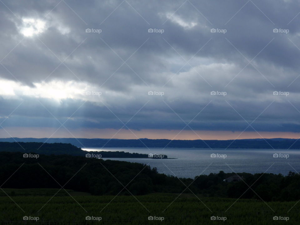 Break in the clouds. Sun shining through clouds over west bay of grand traverse bay 