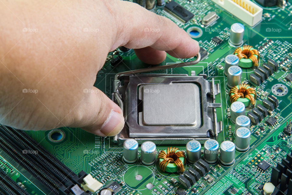 CPU in hand before installation into the motherboard