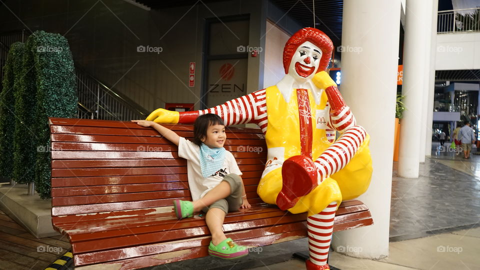 Asian kid sitting with McDonald's 