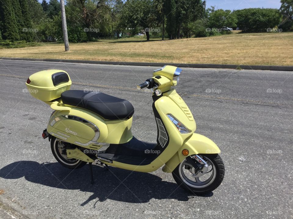 Yellow Vespa Scooter on the Road