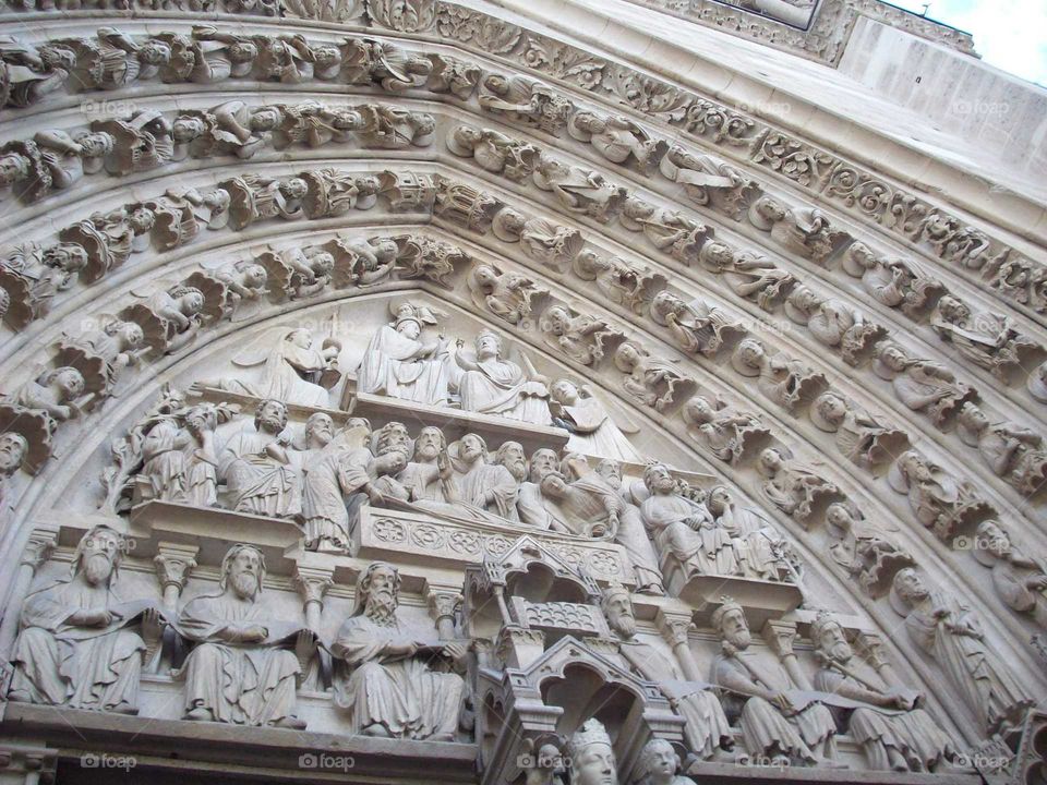 Looking up at the intricate doors of Notre Dame