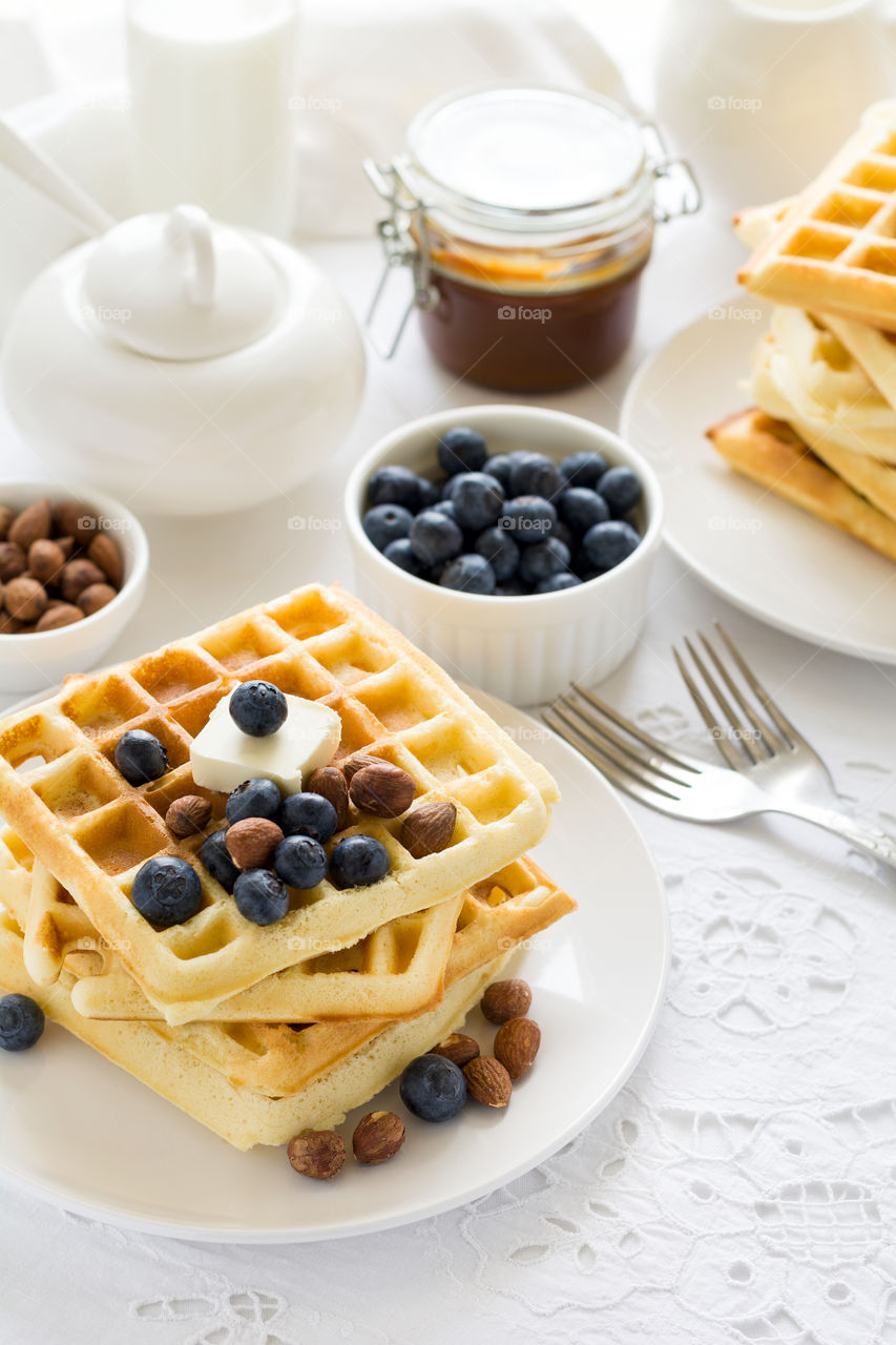 Belgian waffles with butter, blueberry and nuts