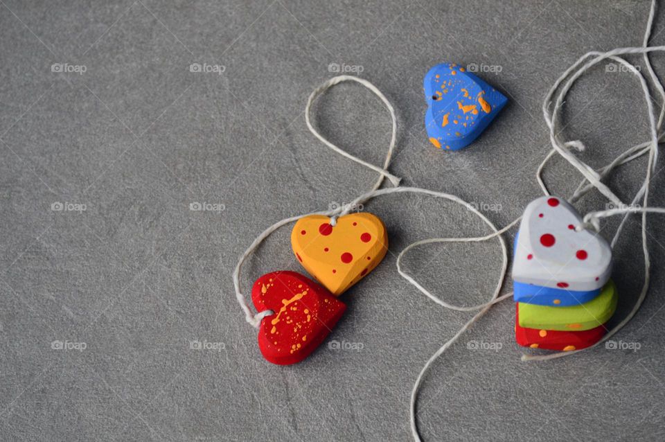 Multicolored wooden hearts on a thread