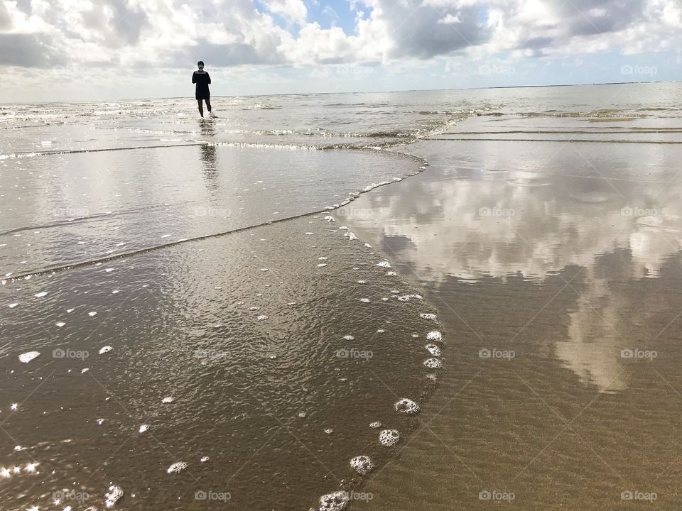 Walking alone in a beach