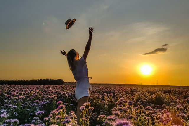 the girl in the field throws up her hat