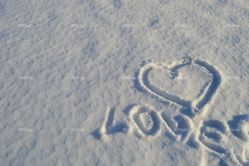 Love word carved on snow