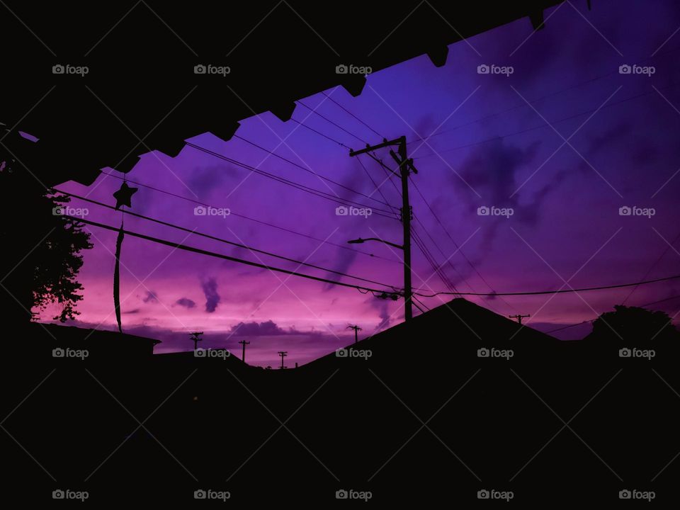 Outline sky dark shadows clouds sunset sunsetting sunrise color colorful silhouette building shape darken define profile contour blacked out delineation solid shape purple nature city house pole lines dusk sundown cloudy skyline beautiful