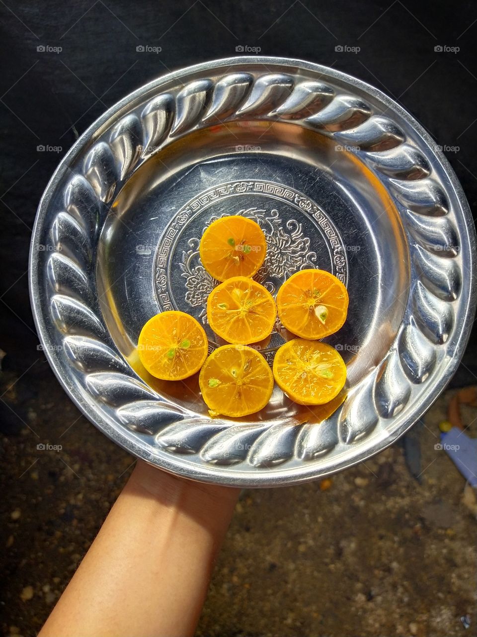 six slices of yellow lemons in a gray plate
