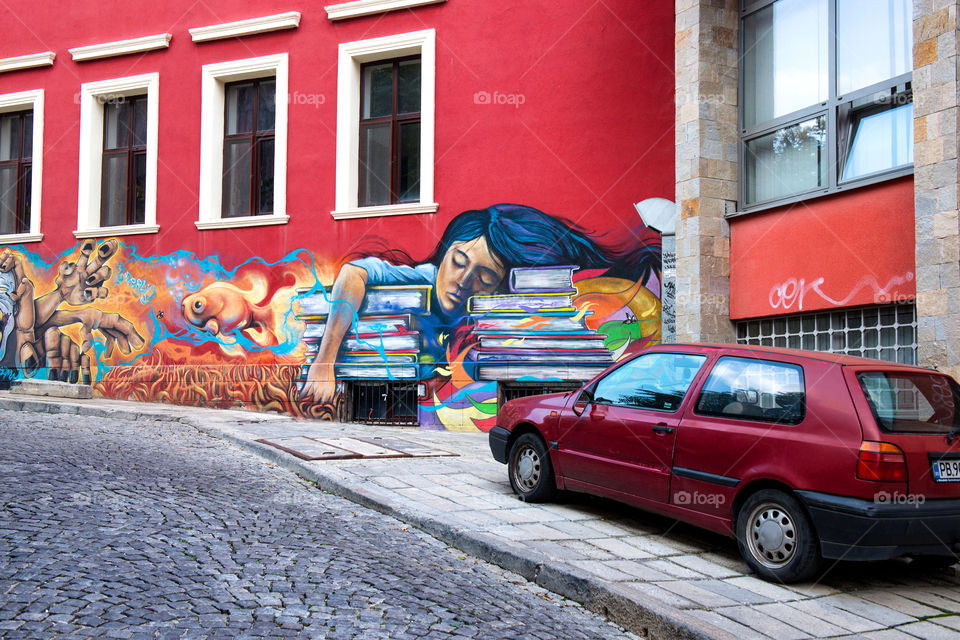 the red car on the red background with graffiti