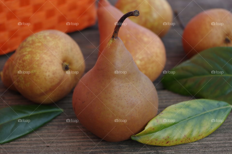 Ripe pear fruits on table