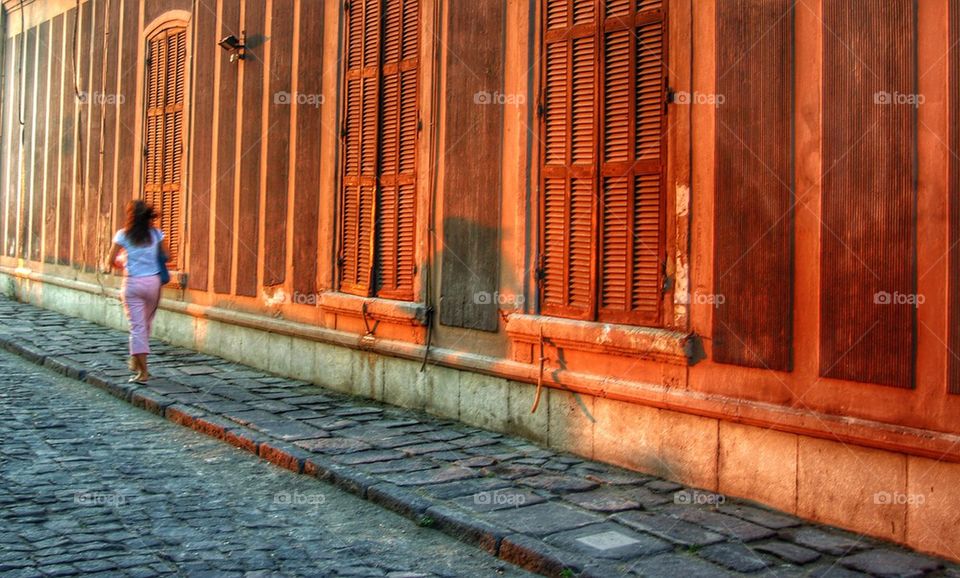 Walking along a red wall. 