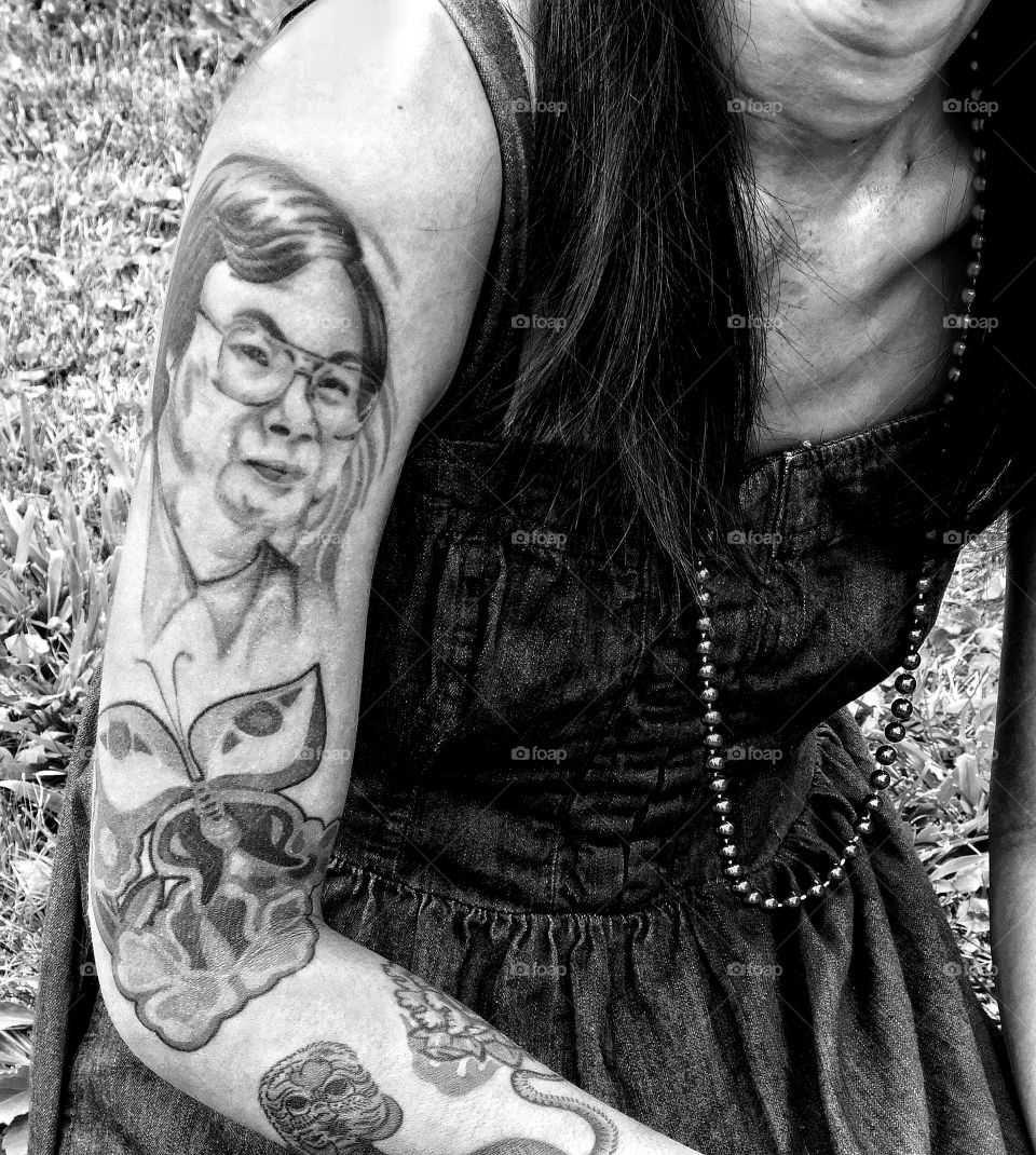 Girl with black and white tattoos of her father